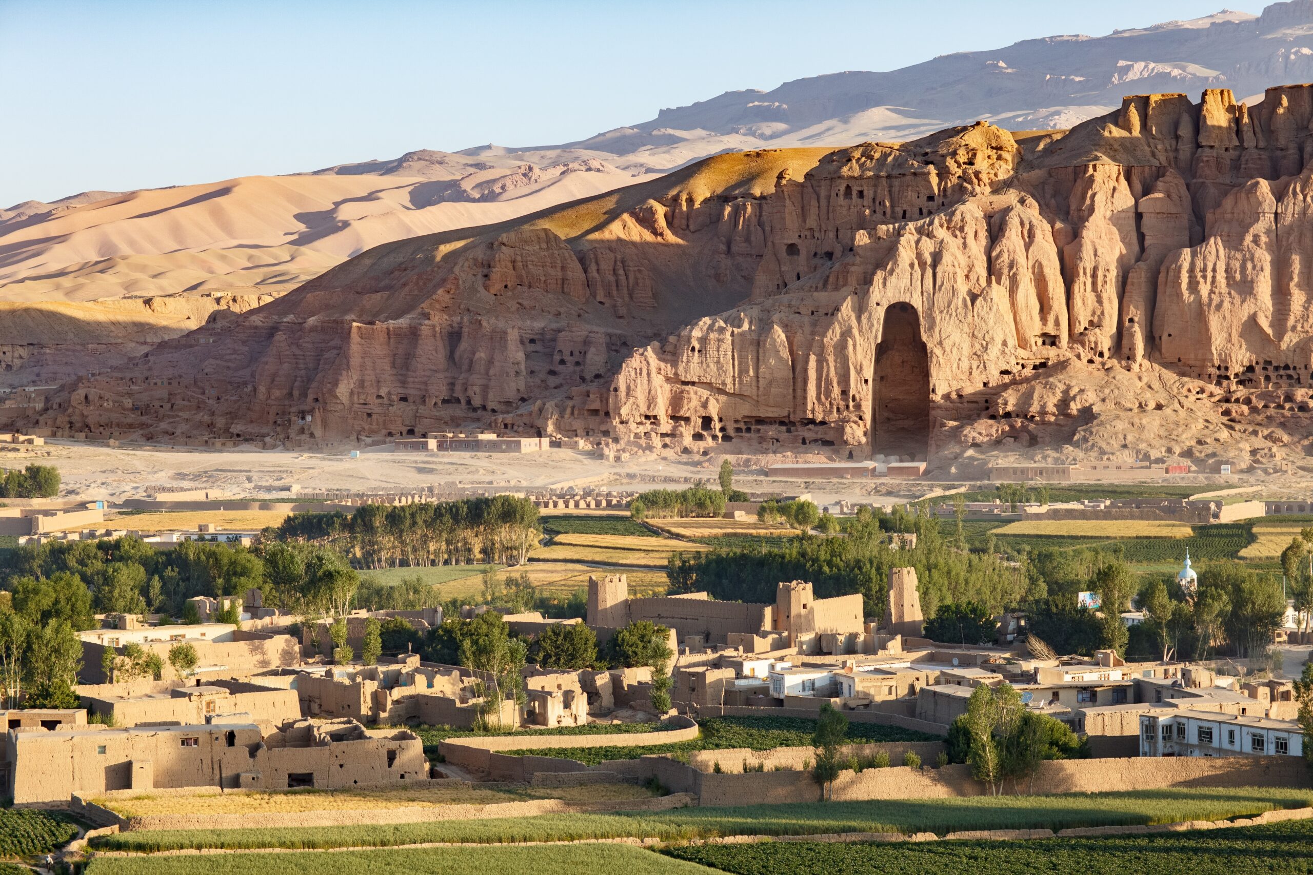 a town in a valley with a large rock mountain